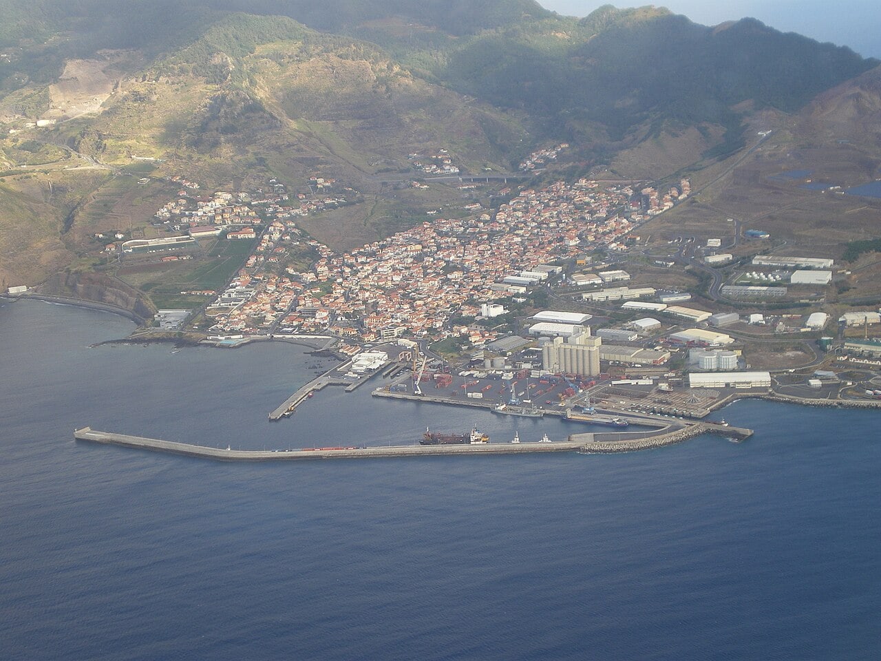 Caniçal’s harbour and town seen from above, with the waterfront to explore below the surrounding hills.