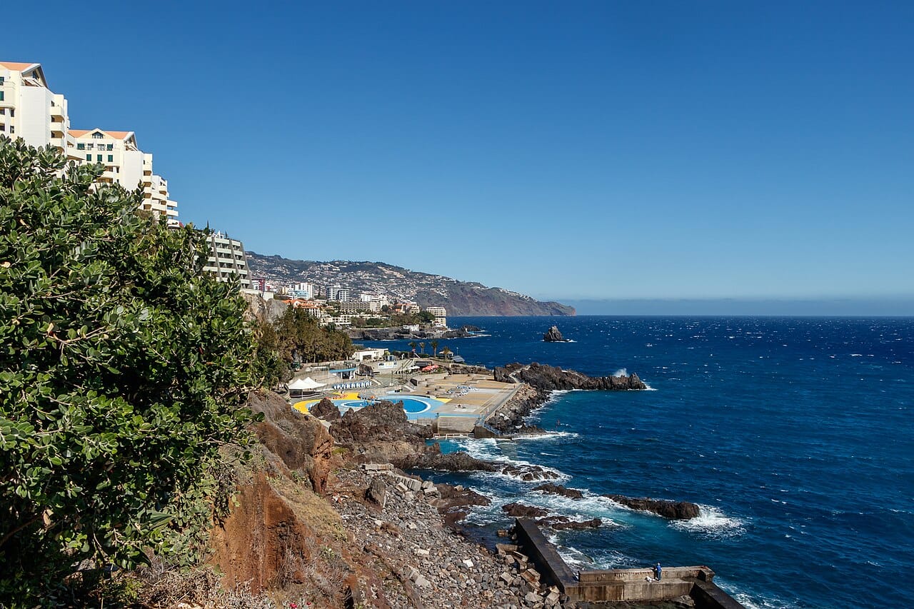 The Lido pools and rocky Funchal shoreline beside the coastal promenade for a seaside walk.