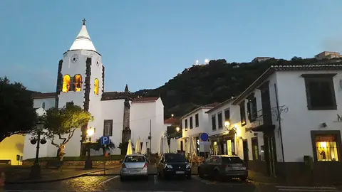 The illuminated church and square in Santa Cruz at dusk, a landmark on an evening town walk.